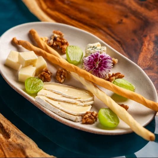Cheese set — Parmesan, brie and gorgonzola cheeses, grapes, walnuts, grissini
