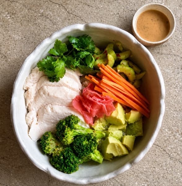 Chicken poke  — A fresh poke bowl with Japanese rice, sous-vide chicken breast, avocado, broccoli, cucumber, carrot,