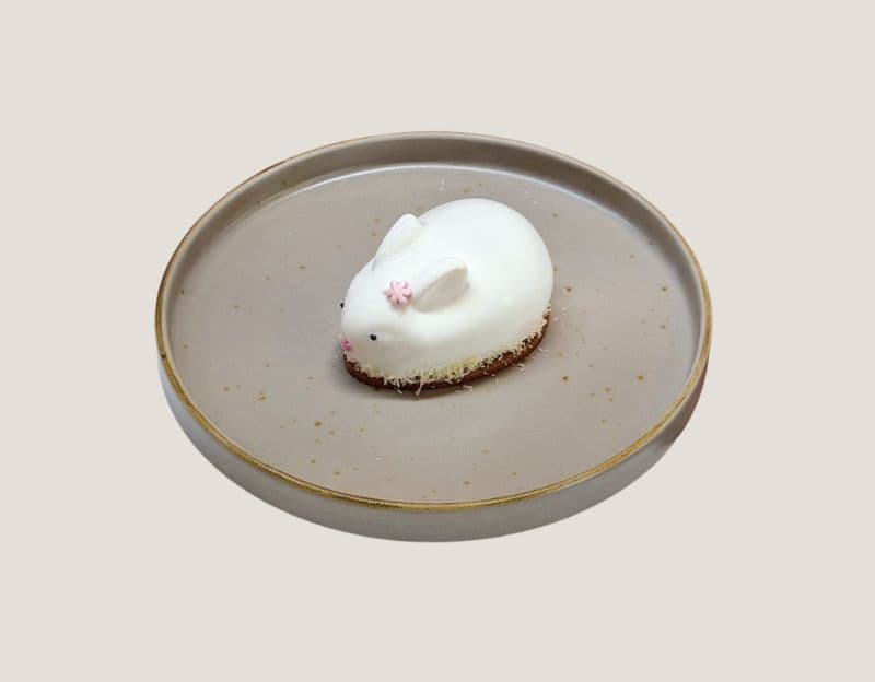 BUNNY COCONUT — Fluffy coconut mousse. 

Inside — white chocolate, almonds, and creamy condensed milk.
A crunchy lay