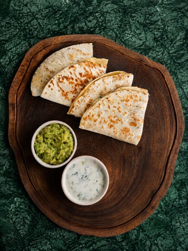 Chicken Quesadilla  — Golden grilled tortilla filled with melted cheese and a flavorful savory filling, served with fresh 