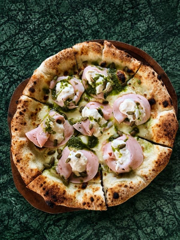 Mortadella & Stracciatella — A wood-fired pizza topped with delicate slices of premium mortadella, creamy stracciatella cheese, f