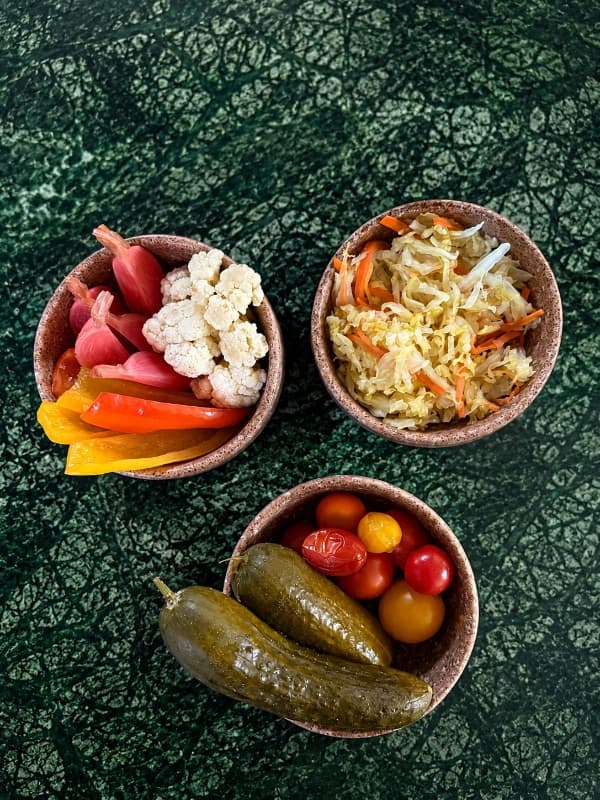 Pickles veggies  — A colorful selection of house-pickled vegetables, including crisp cucumbers, cherry tomatoes, pepper
