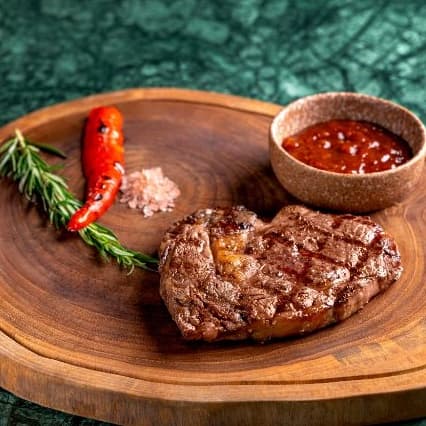 Ribeye — Premium grilled ribeye steak with rich marbling and deep beef flavor. Juicy, tender, and perfectly c