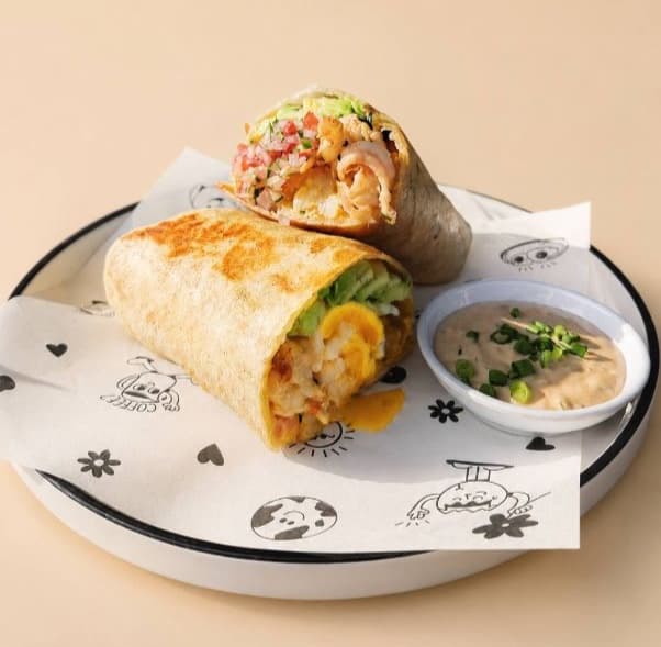 Baja shrimp burrito — Tortilla, shrimps, avocado, 2 sunny side up eggs, potato tots, pickled red onion, ranch sauce