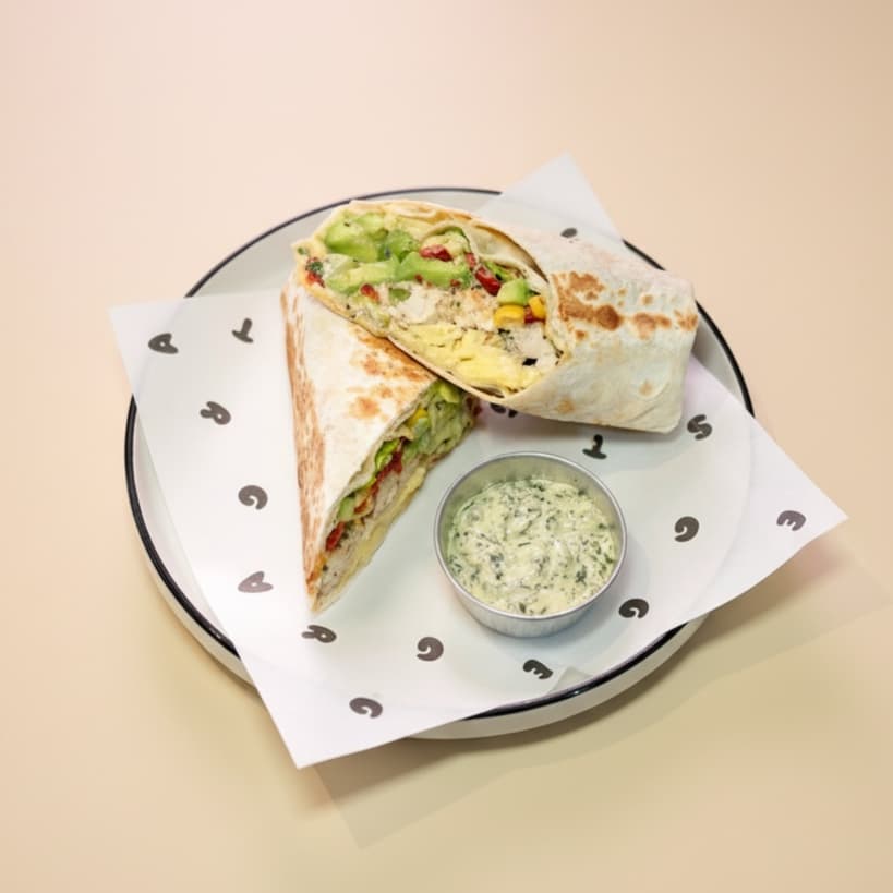 Breaky burrito — Tortilla, 2 egg, chicken, green aioli sauce, avocado, tomato, bell pepper, romano salad, sweet corn