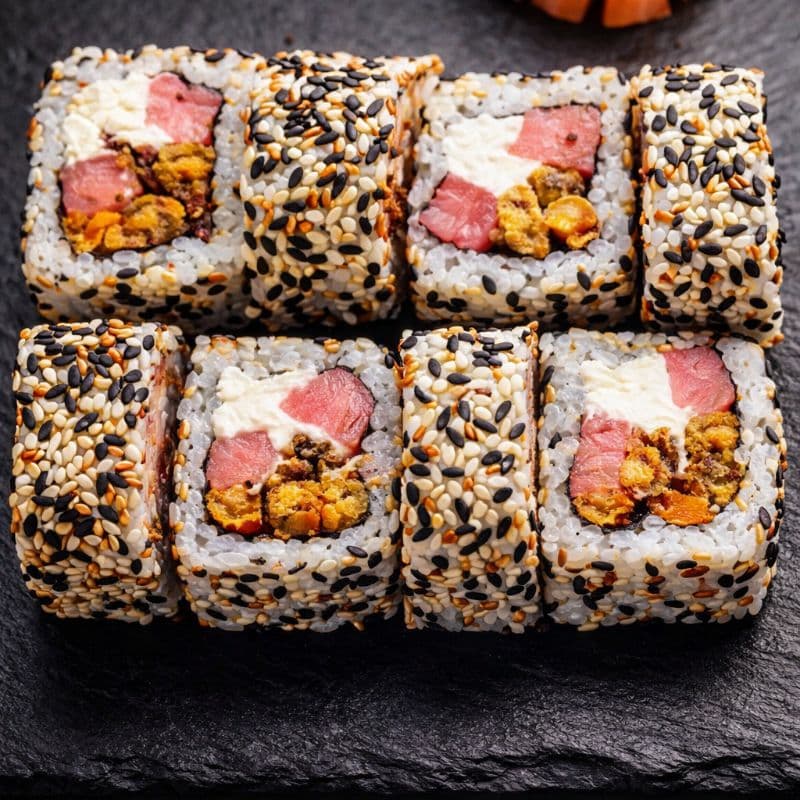 Spicy Kawaii Iga Uramaki — A roll with tuna, mussels, cream cheese and mix sesame for a balanced flavor