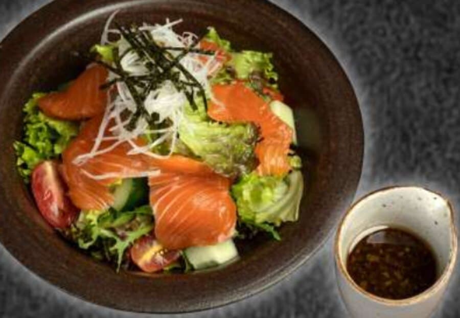 Salmon Salad — Sliced salmon, mix lettuce, cucumber, cherry tomato, turnip slices, nori slices, onion dressing